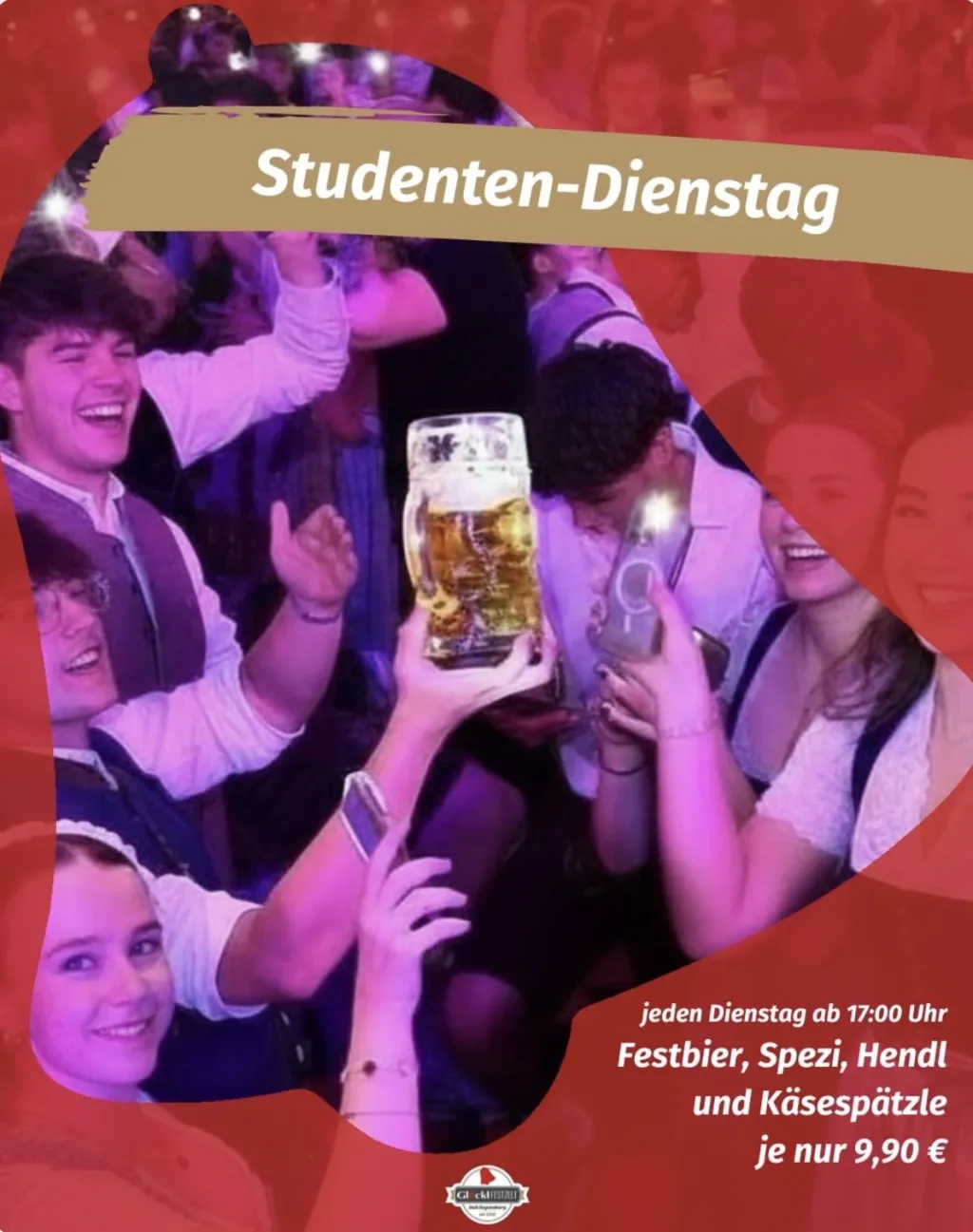 Studenten-Dienstag: junge Menschen in Tracht feiern im Festzelt, einer hält eine Maß hoch